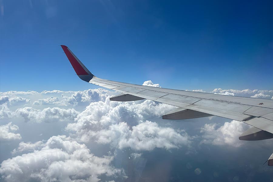 Ala de avión sobrevolando Asia entre las nubes